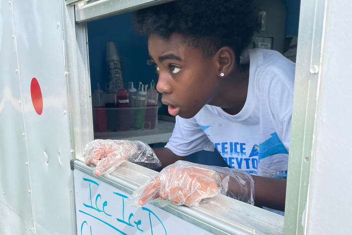 Dreyton McDonald sells snow cones from his mobile shop, Ice Ice Dreyton, in Ocala, Fla.
