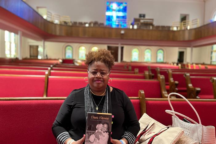 Lisa McNair holds her memoir <em>Dear Denise: Letters to the Sister I Never Knew</em>, recounting growing up in Birmingham, Ala., after her sister Denise and three other Black girls were murdered in the Ku Klux Klan bombing of 16th Street Baptist Church.