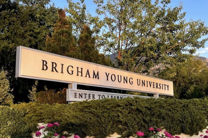 Brigham Young University's athletics department says it "sincerely apologizes" to the fan who was banned for allegedly yelling racist slurs at volleyball players from visiting Duke University.