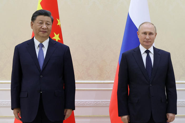 China's President Xi Jinping and Russian President Vladimir Putin pose during their trilateral meeting with Mongolia on the sidelines of the Shanghai Cooperation Organization summit in Samarkand, Uzbekistan, on Thursday.