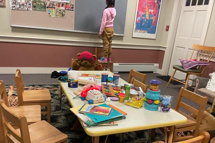 A young girl is shown staying at a shelter on Martha's Vineyard, Mass., after she and dozens of other migrants arrived by plane unannounced Wednesday.