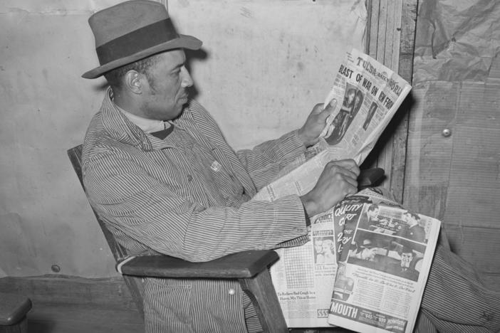 Ken Burns' new three-part documentary, <em>The U.S. and the Holocaust,</em> explores what everyday Americans knew — or didn't know — about what the Nazis were doing in Europe. Above, a tenant farmer reads a newspaper in Creek County, Okla., in February 1940.