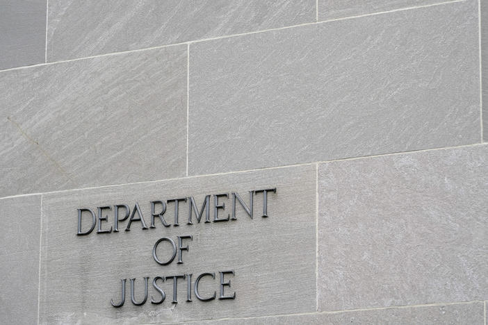 A sign marks the facade of the Department of Justice building in Washington on May 5, 2022.