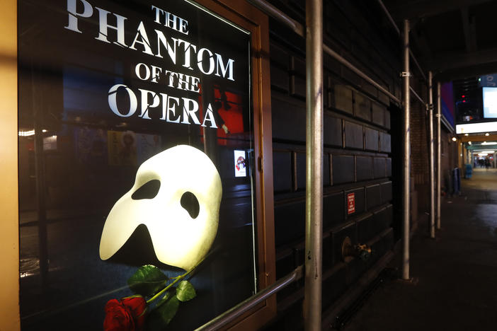 A poster advertising "The Phantom of the Opera" is displayed on the shuttered Majestic Theatre in New York on March 12, 2020. Broadway's longest-running show is scheduled to close in February 2023.