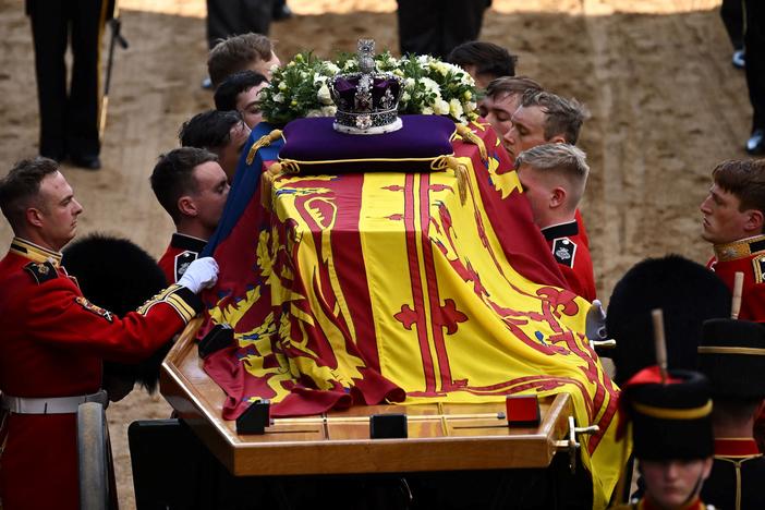 Pallbearers from the Queen's Company, 1st Battalion Grenadier Guards, prepare to carry the coffin of Queen Elizabeth II into Westminster Hall at the Palace of Westminster in London on Wednesday to lie in state following a procession from Buckingham Palace. Elizabeth's funeral is Monday.