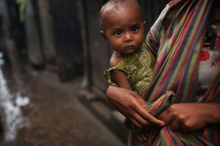 A women holds a child in the alley of a slum in Dhaka, Bangladesh. Bangladesh is one of the world's poorest countries; nearly 40% of the population survive on less than a dollar a day.