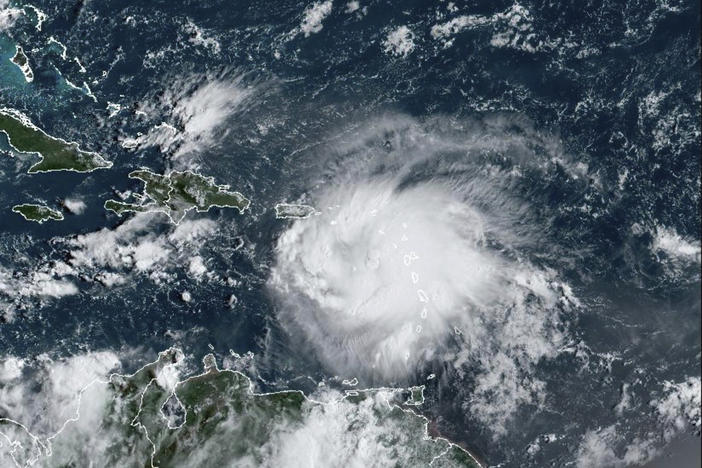A satellite image shows Tropical Storm Fiona in the Caribbean on Saturday. Fiona threatened to dump up to 20 inches of rain in Puerto Rico as forecasters placed the U.S. territory under a hurricane warning and people braced for potential landslides, severe flooding and power outages.