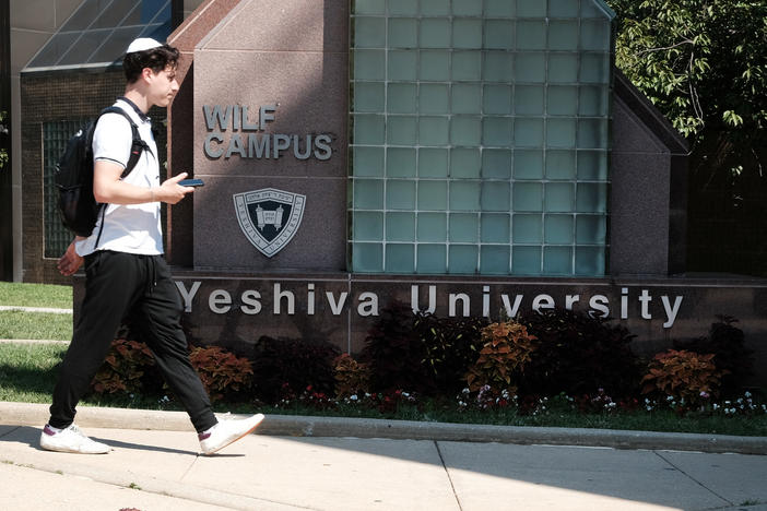 People walk by the campus of Yeshiva University in New York City on Aug. 30. The school told students in an email that it was pausing all student clubs on campus.