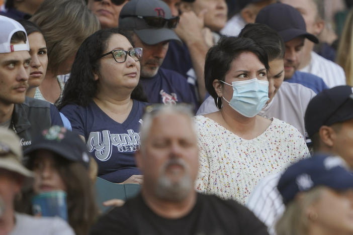 A person in the stands wears a mask before Dr. Anthony Fauci threw out the first pitch, at a baseball game between the Seattle Mariners and the New York Yankees, on Aug. 9 in Seattle. Fauci is President Biden's chief medical adviser and director of the National Institute of Allergy and Infectious Diseases.