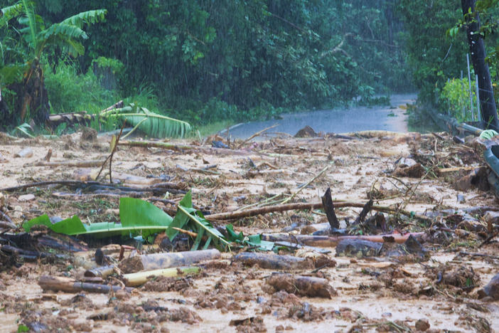 A road is blocked by a mudslide caused by Hurricane Fiona in Cayey, Puerto Rico, Sunday, Sept. 18, 2022.
