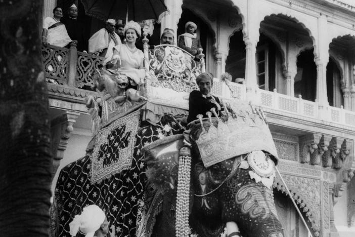Queen Elizabeth II rides on an elephant during one of her three official visits to India. This photo is from February 1961.