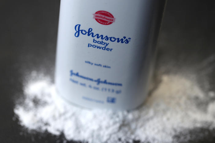 A bottle of Johnson & Johnson baby powder is displayed on a table. J&J pulled its iconic Johnson's baby powder off the shelves in the U.S. in 2020.