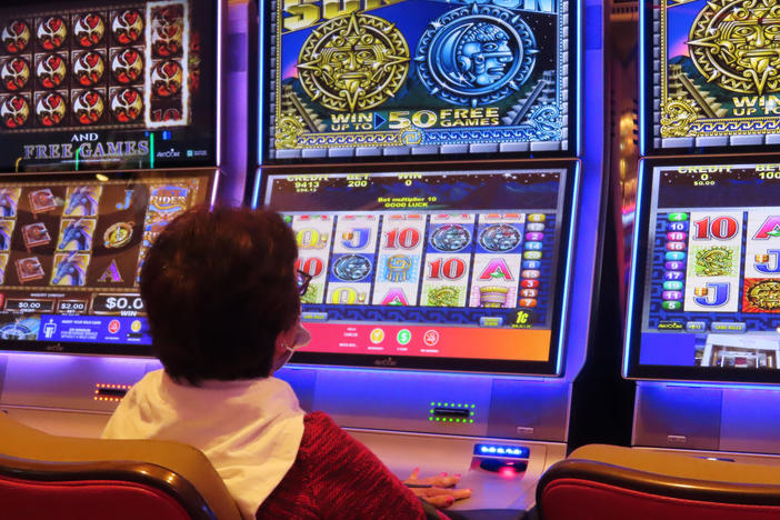 A gambler plays a slot machine at the Hard Rock casino in Atlantic City, N.J. on Aug. 8, 2022.
