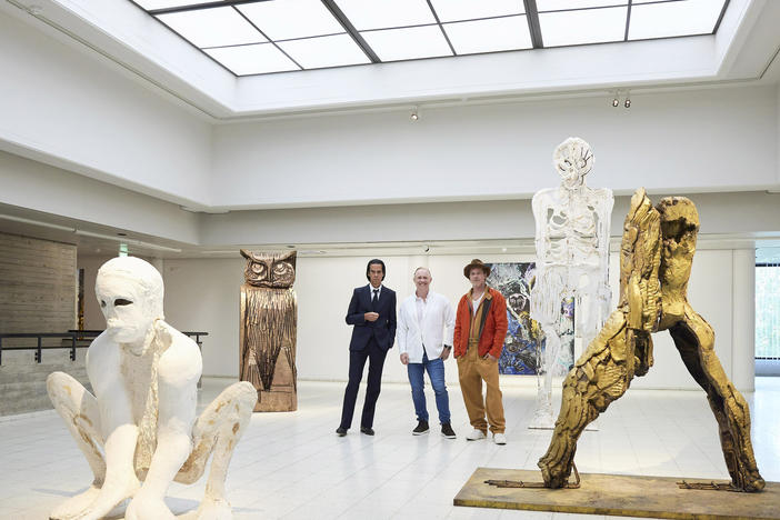 Musician Nick Cave (from left), artist Thomas Houseago and with actor Brad Pitt pose prior to the opening of their joint exhibition, in Tampere, Finland, on Saturday.