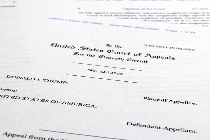 Pages from a U.S. Court of Appeals for the 11th Circuit in Atlanta ruling that lifts a judge's hold on the Justice Department's ability to use classified documents seized by the FBI at Trump's Mar-a-Lago estate.