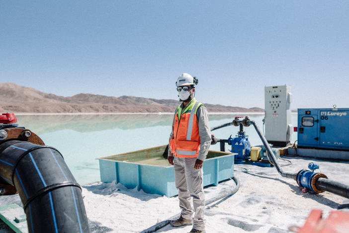 A worker performs maintenance on pipes used during brine extraction at a lithium mine in the Atacama Desert in Chile on Aug. 24.