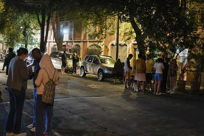 People gather outside after an earthquake was felt in Mexico City, Thursday, Sept. 22, 2022.