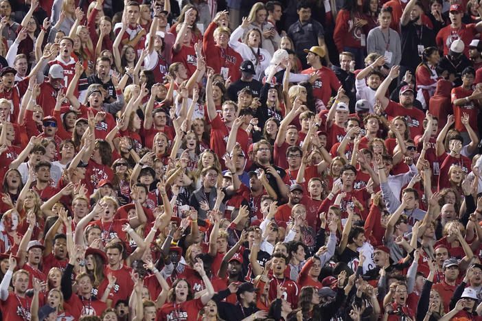 The Utah student section show their support during the first half of an NCAA college football game against San Diego State and Utah on Sept. 17, in Salt Lake City. A University of Utah student was arrested on suspicion of making terrorist threats after police said she threatened to detonate a nuclear reactor if the school's football team failed to win the game against San Diego.