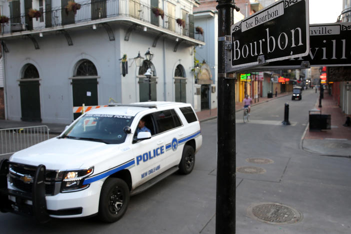 A New Orleans police vehicle patrols Bourbon Street.