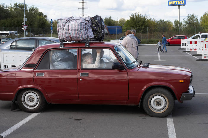 People arrive at a parking lot in Zaporizhzhia from places like Melitopol and Kherson, areas that have been occupied by Russia for months now.