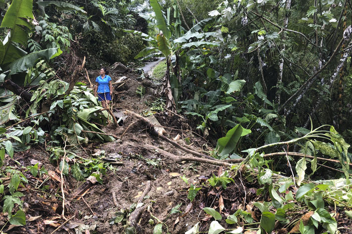 Nancy Galarza looks Thursday at the damage that Hurricane Fiona inflicted on her community, which remained cut off days after the storm slammed the rural community of San Salvador in the town of Caguas, Puerto Rico.