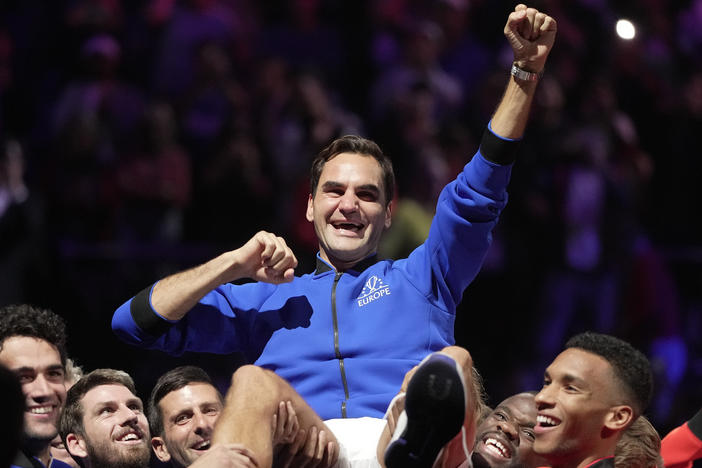 Team Europe's Roger Federer is lifted by fellow players after playing with Rafael Nadal in a Laver Cup doubles match against Team World's Jack Sock and Frances Tiafoe at the O2 arena in London, Friday, Sept. 23.