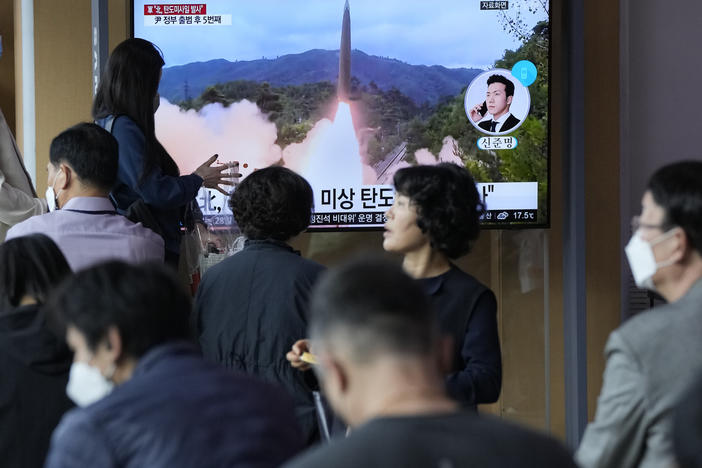 People watch a news program showing a file image of a missile launch by North Korea at the Seoul Railway Station on Sunday. South Korea has accused its neighbor of raising tensions in the region after firing a ballistic missile toward the sea.