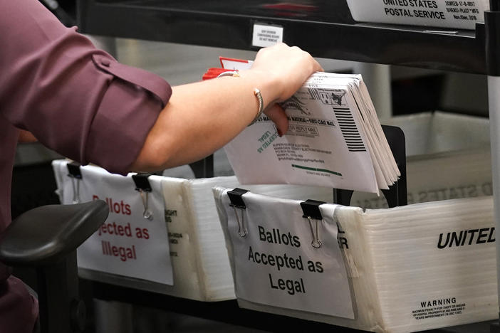 In this 2020 file photo, an election worker sorts vote-by-mail ballots at the Miami-Dade County Board of Elections in Doral, Fla. Florida is one of about half of U.S. states that have ballot curing provisions.