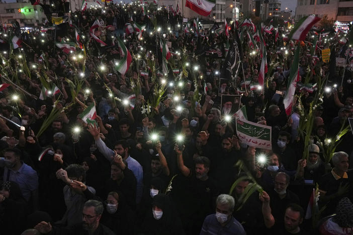 Pro-government demonstrators attend a rally condemning recent anti-government protests over the death of Mahsa Amini, a 22-year-old woman who had been detained by the nation's morality police in Tehran earlier this month.