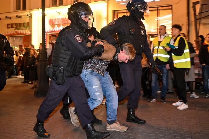 Police officers detain a man in Moscow on Wednesday, following calls to protest against mobilization announced by President Vladimir Putin.