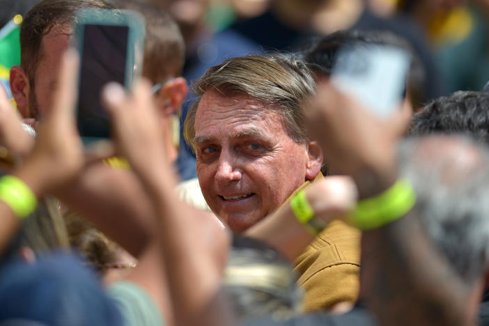 Brazil's President Jair Bolsonaro greets supporters during a reelection campaign rally. Ahead of the first round of voting on Oct. 2, Bolsonaro has baselessly claimed that voting machines will be rigged against him, an echo of former U.S. President Donald Trump's false claims about the 2020 election.