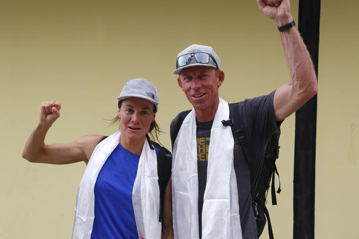 Hilaree Nelson of Telluride, Colorado, left and James Morrison of Tahoe, California, raise their fists as the pair arrived in Kathmandu, Nepal, in 2018. Rescuers in a helicopter were searching on the world's eighth-highest mountain Tuesday for Nelson, the famed U.S. ski mountaineer, a day after her trip organizer said she fell off the mountain near the peak.