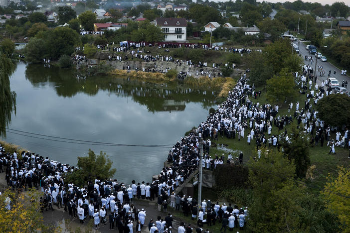 Jewish pilgrims gather at a lake to perform Tashlikh, an atonement ritual that involves symbolically casting one's sins into a body of water, during the Rosh Hashanah pilgrimage to Rabbi Nachman's tomb in Uman, Ukraine on Monday. Despite Russia's invasion of Ukraine, a reported 23,000 adherents made the trip, which was complicated by the grounding of civilian aviation throughout Ukraine.