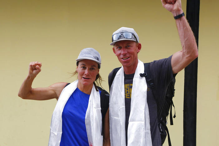 Hilaree Nelson of Telluride, Colo., left, and James Morrison of Tahoe, Calif., raise their fists in October 2018 as the pair arrived in Kathmandu, Nepal.