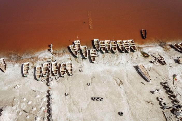 This areal view shows rows of boats used for harvesting salt in Lake Retba in Senegal in 2021.