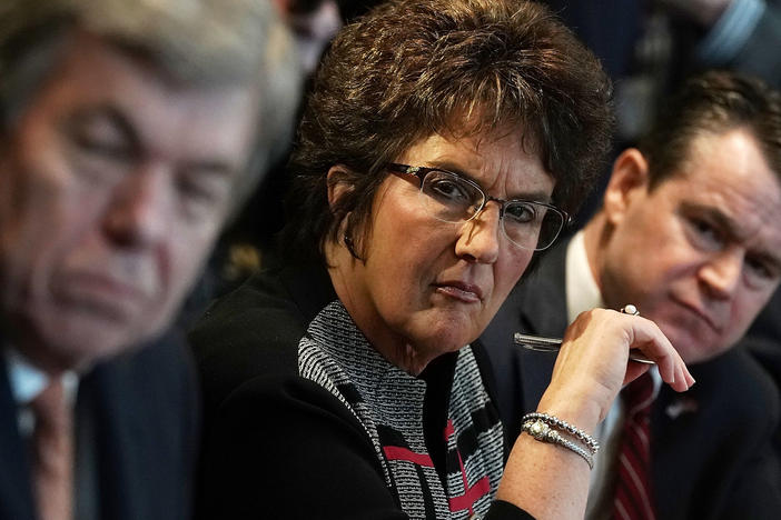 Rep. Jackie Walorski (R-IN) sits between Sen. Roy Blunt (R-MO) and Sen. Todd Young (R-IN) during a meeting between President Donald Trump and congressional members on Feb. 13, 2018.