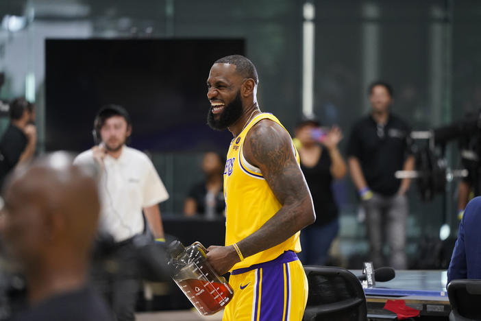 Los Angeles Lakers' LeBron James shares a laugh with staff members during the NBA basketball team's Media Day Monday, Sept. 26, 2022, in El Segundo, Calif.