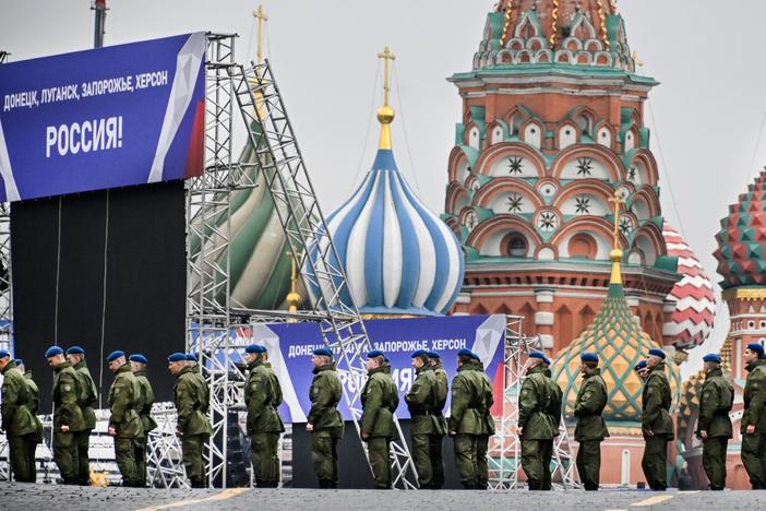 Russian soldiers stand on Red Square in central Moscow on Thursday as the square is sealed off prior to a ceremony for the alleged incorporation of new territories into Russia. Banners on the stage read: "Donetsk, Luhansk, Zaporizhzhia, Kherson — Russia!"
