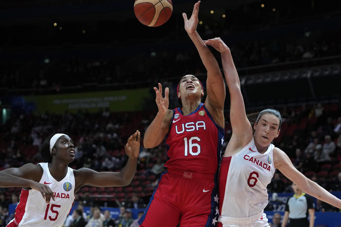 The United States' Brionna Jones (center) is fouled by Canada's Bridget Carleton, (right) during their semifinal game at the women's Basketball World Cup in Sydney on Friday.
