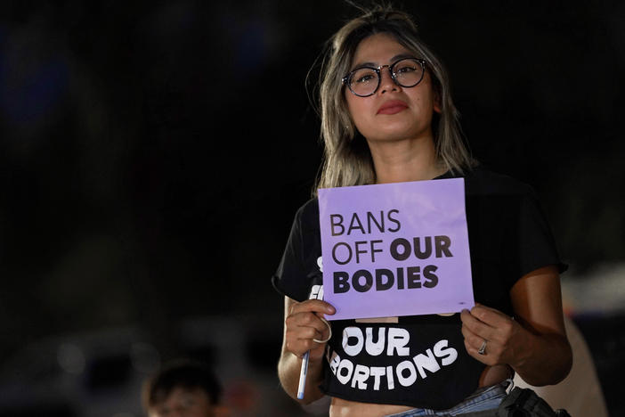 Celina Washburn protests outside the Arizona Capitol to voice her dissent with an abortion ruling, on Sept. 23, 2022, in Phoenix.