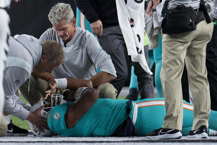 Medical staff attend to Miami Dolphins quarterback Tua Tagovailoa after he was sacked by Cincinnati Bengals defensive tackle Josh Tupou during an NFL game on Thursday.