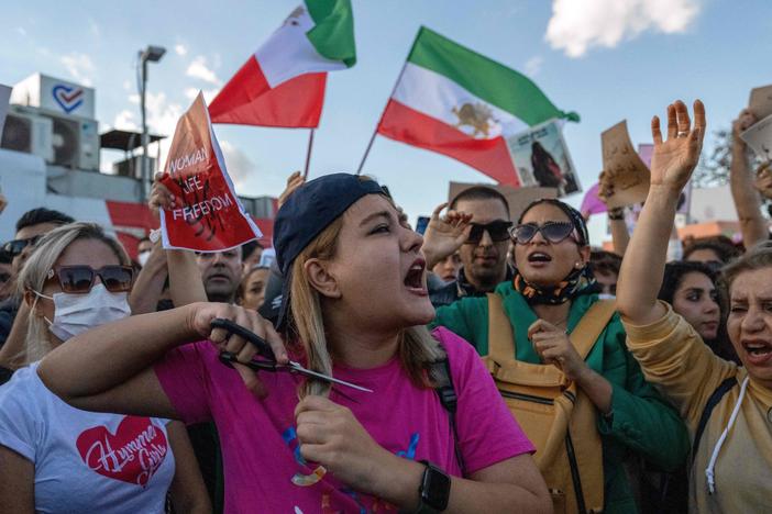 A protestor cuts her hair during a demonstration against the Iranian government and in support of Iranian women in Istanbul on Sunday.