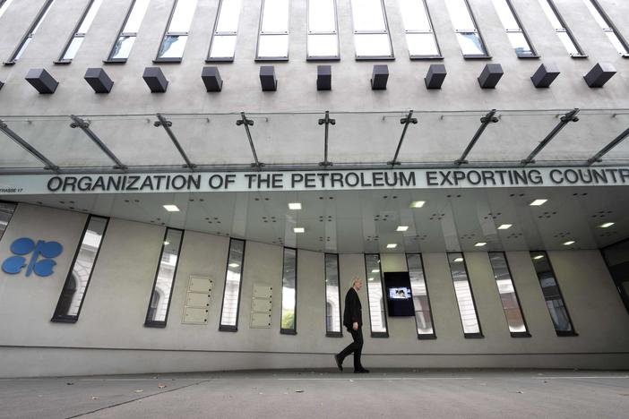 A man walks past OPEC headquarters in Vienna on Tuesday on the eve of the 45th meeting of the Joint Ministerial Monitoring Committee and the 33rd OPEC and non-OPEC Ministerial Meeting. The in-person meeting of OPEC members led by Saudi Arabia and allied members headed by Russia will be the first in the Austrian capital since the spring of 2020.