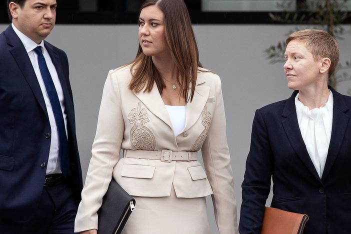 Brittany Higgins, center, leaves the courthouse in Canberra, Australia, on Wednesday.