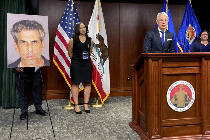 Los Angeles District Attorney George Gascon stands by a photo of TV producer Eric Weinberg during a news conference to announce sexual assault charges against Weinberg on Wednesday in Los Angeles.