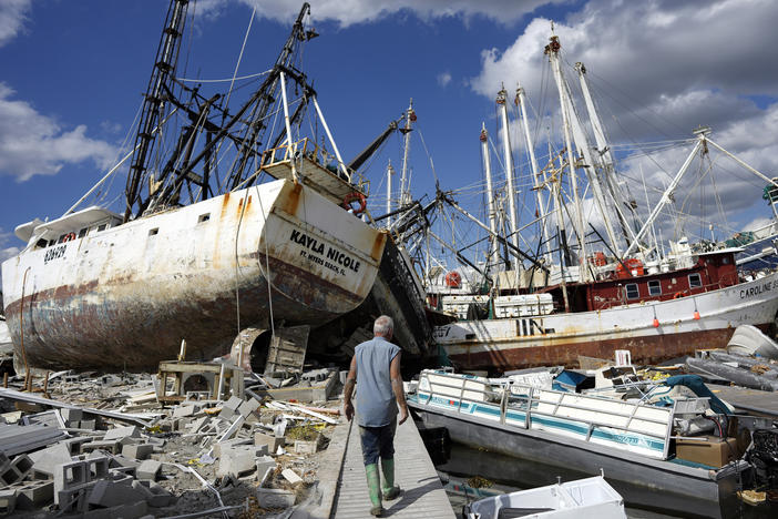 "Wrecked shrimp boats and other vessels littered the waterfront on San Carlos Island, Fort Myers Beach, FL, one week after Hurricane Ian made landfall.