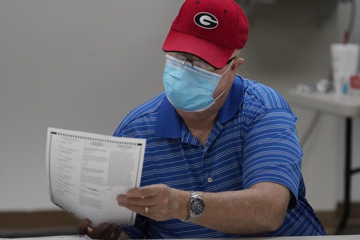 A Georgia election official examines a ballot during that state's hand-count audit in 2020.
