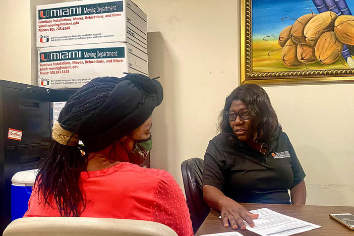 Nicole Daceus, who was recently tested for HPV through the University of Miami's Sylvester Comprehensive Cancer Center, speaks with Valentine Cesar (right), a community health worker. Having a culturally competent staff can be key to cutting through health care avoidance and fear, Cesar says.