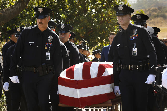 Los Angeles Police Department officers carry the casket of LAPD Officer Houston R. Tipping at the beginning of his memorial service on Wednesday, June 22, in Los Angeles.