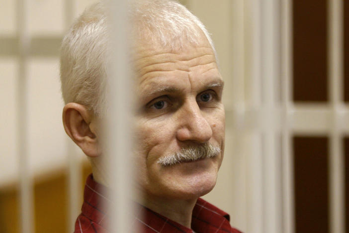 Ales Bialiatski, the head of Belarusian Vyasna rights group, stands in a defendants' cage during a court session in Minsk, Belarus, in 2021.